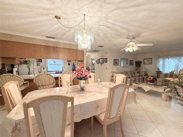 dining room featuring a textured ceiling, ceiling fan with notable chandelier, and crown molding