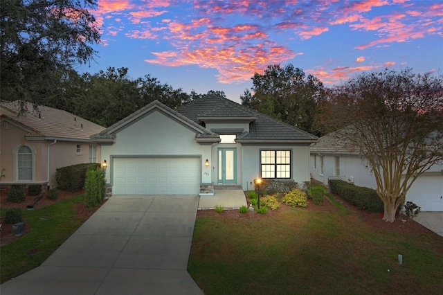 view of front of house featuring a yard and a garage