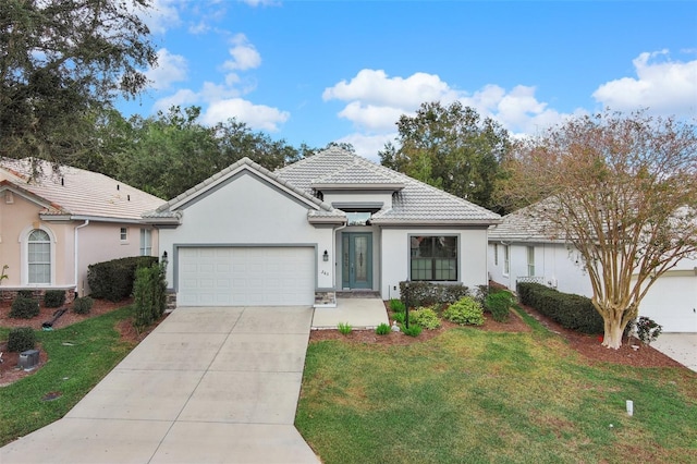 view of front of house with a garage and a front yard