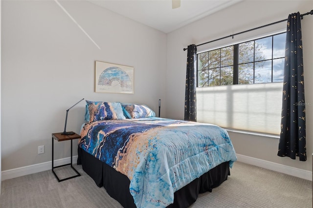 bedroom with carpet flooring, ceiling fan, and multiple windows