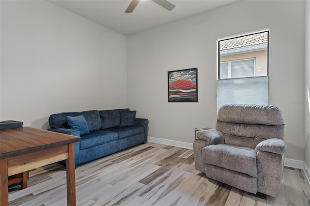 living area with ceiling fan, light hardwood / wood-style flooring, and plenty of natural light