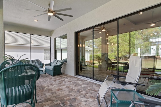 sunroom / solarium with ceiling fan and a wealth of natural light