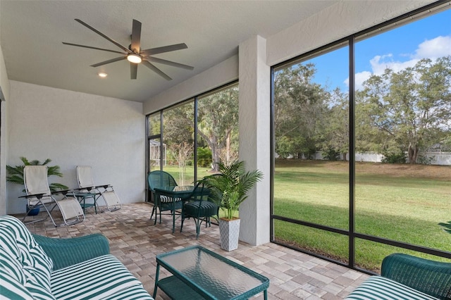 sunroom featuring ceiling fan