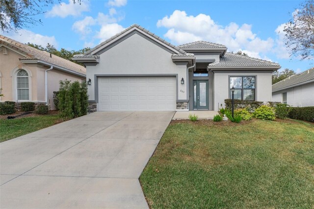 view of front facade featuring a front lawn and a garage