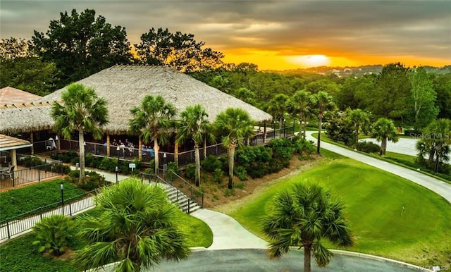 view of community with a lawn and a water view