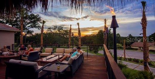 deck at dusk with an outdoor hangout area