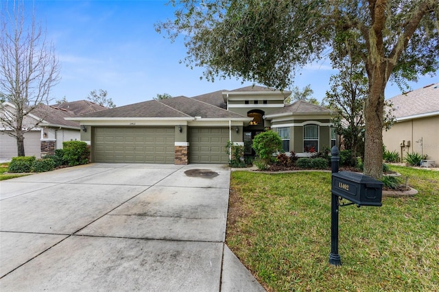 view of front of property with a garage and a front lawn