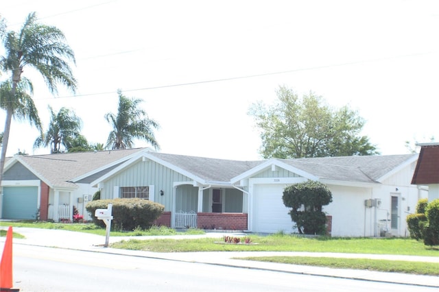 ranch-style house featuring a front yard and a garage