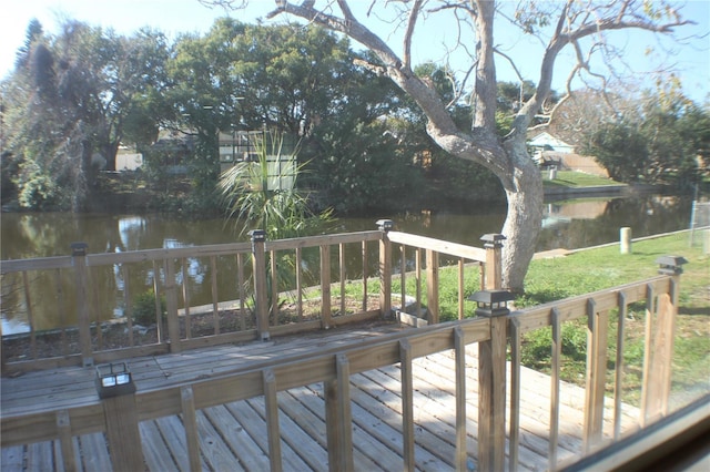 wooden deck featuring a water view