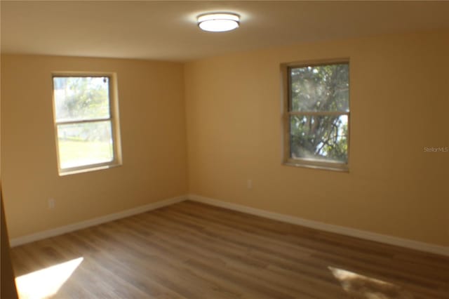 spare room with hardwood / wood-style floors