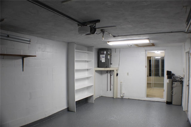 garage featuring electric water heater and a garage door opener