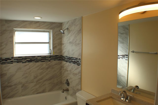 full bathroom featuring vanity, toilet, and tiled shower / bath