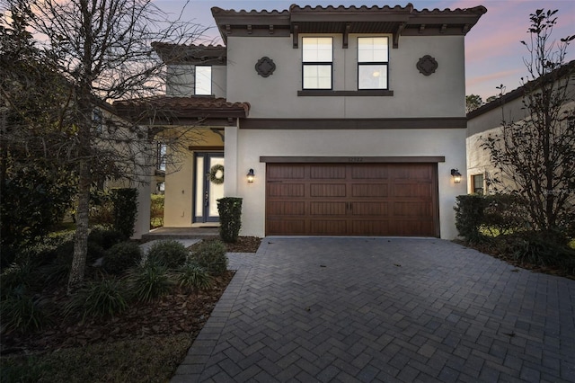 mediterranean / spanish house with a garage