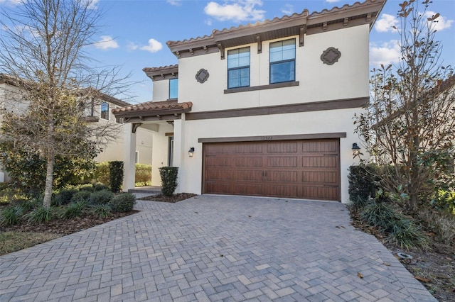 mediterranean / spanish-style home featuring a garage