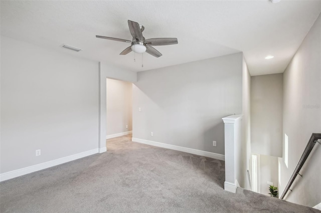 empty room featuring light carpet and ceiling fan