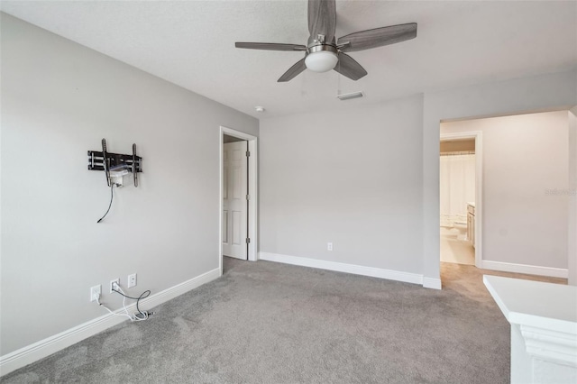 carpeted empty room featuring ceiling fan