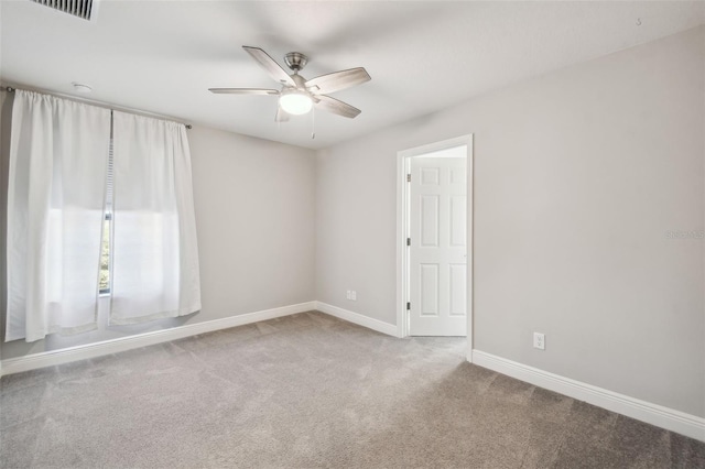 spare room featuring carpet floors and ceiling fan