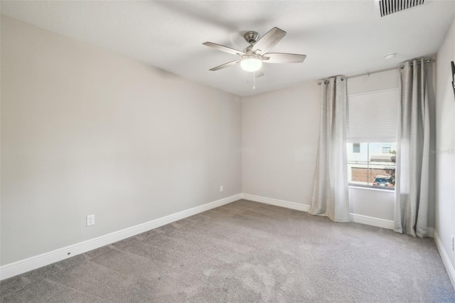 carpeted spare room with ceiling fan