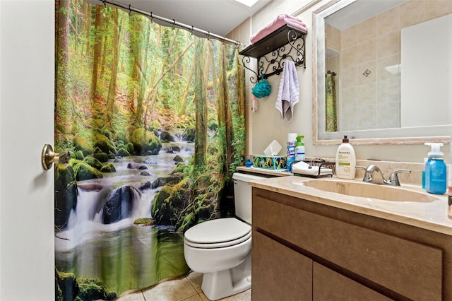 bathroom featuring tile patterned floors, vanity, and toilet