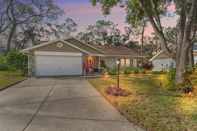 single story home featuring a yard and a garage