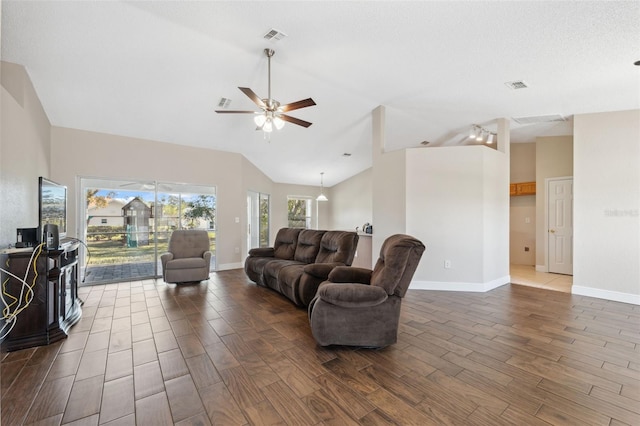 living room with a textured ceiling, high vaulted ceiling, and ceiling fan