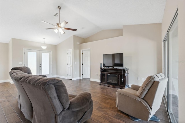 living room with french doors, dark hardwood / wood-style floors, vaulted ceiling, and ceiling fan