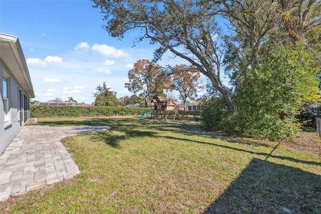 view of yard featuring a patio and a playground