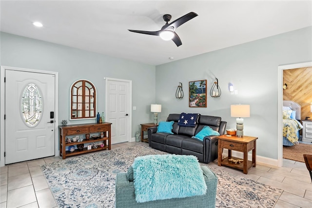 tiled living room featuring ceiling fan