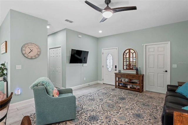 living room with ceiling fan and light tile patterned flooring