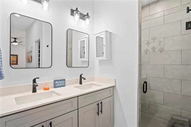 bathroom with ceiling fan, a shower with door, and vanity