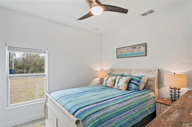 tiled bedroom featuring ceiling fan