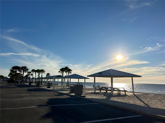 view of community with a water view and a beach view