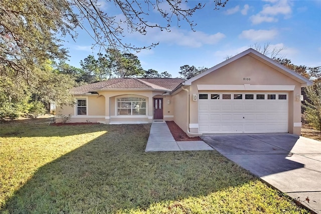 ranch-style home with a garage and a front lawn