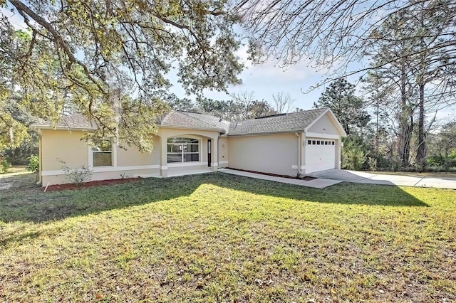 ranch-style house featuring a front yard and a garage