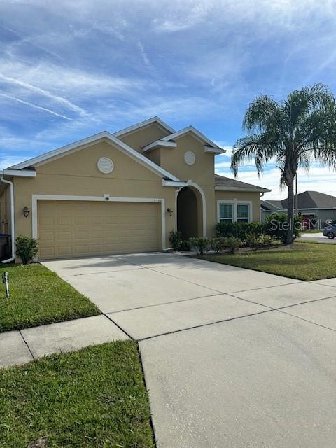 view of front facade with a front yard and a garage