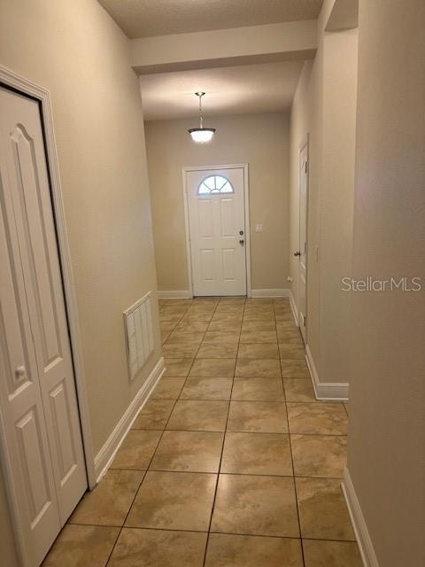 entryway featuring light tile patterned floors