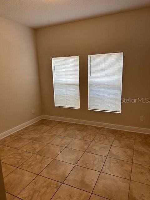 spare room with light tile patterned floors