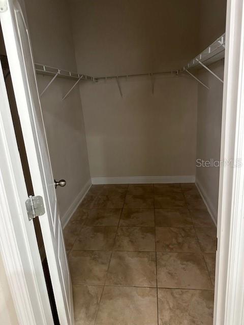 spacious closet with tile patterned flooring