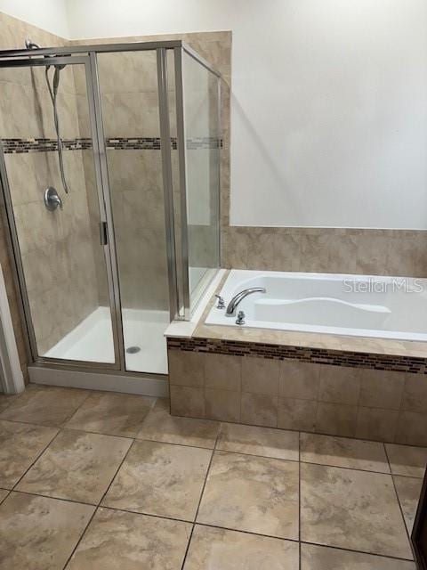 bathroom with tile patterned flooring and independent shower and bath