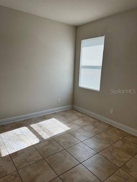 spare room with light tile patterned floors