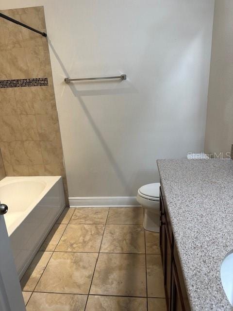 full bathroom featuring tile patterned flooring, vanity, toilet, and tiled shower / bath combo