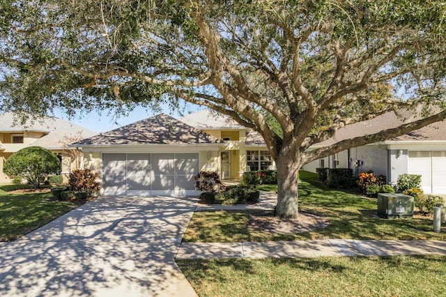 single story home featuring a front lawn and a garage