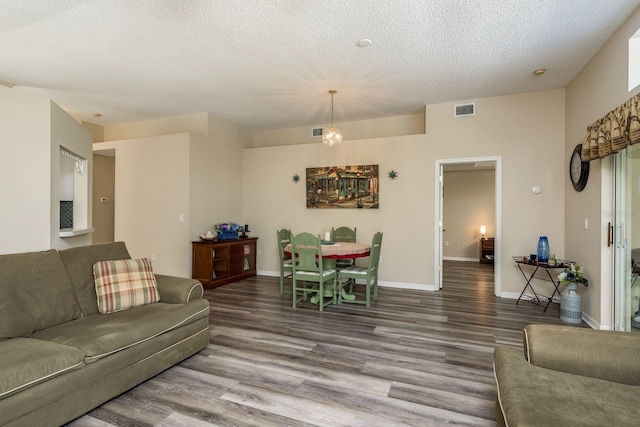 living room featuring wood-type flooring and a textured ceiling