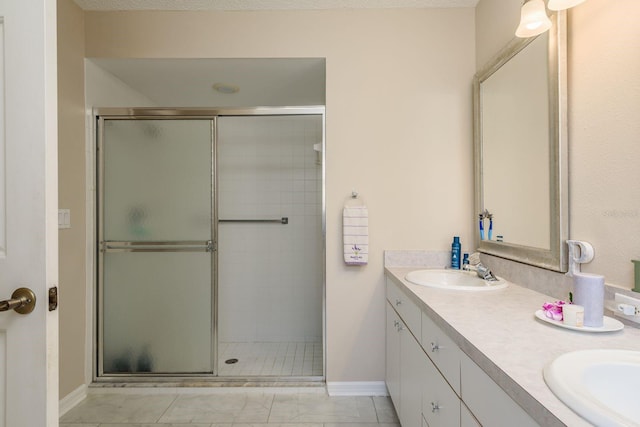 bathroom featuring vanity and a shower with shower door