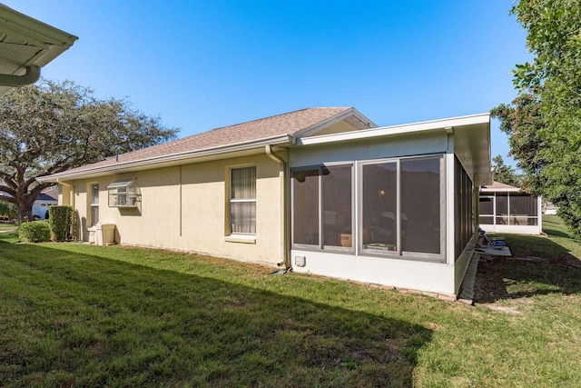 back of property featuring a sunroom and a yard