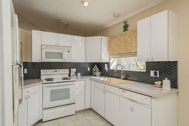 14120 Whitecap Ave, Hudson, FL 34667 - kitchen featuring white appliances, light marble finish flooring, light countertops, backsplash, and white cabinetry