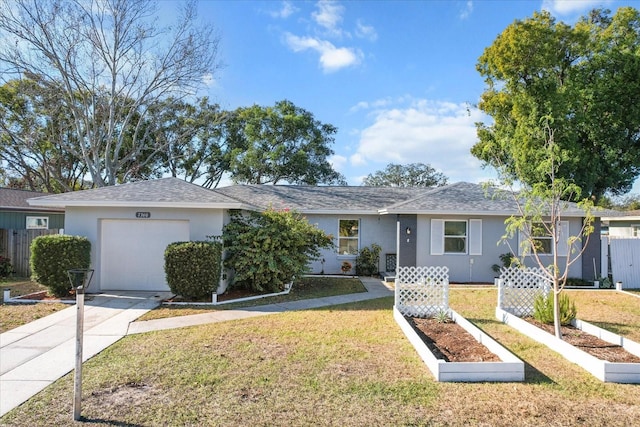 ranch-style home featuring a garage and a front lawn