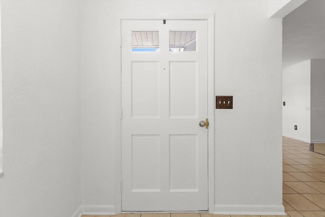 foyer entrance with light tile patterned floors