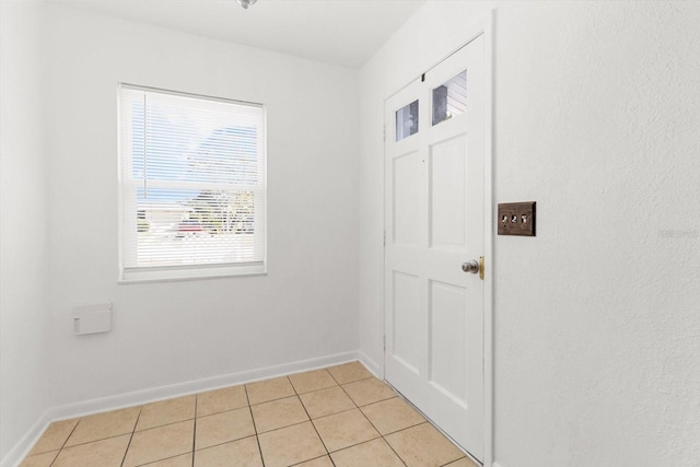 doorway with light tile patterned floors