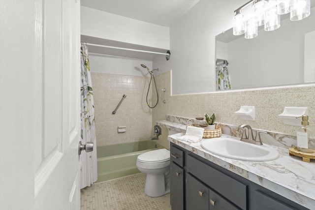 full bathroom featuring vanity, tile patterned flooring, toilet, shower / bath combo with shower curtain, and tile walls